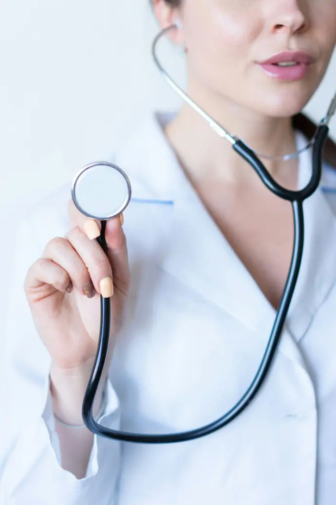cliczen a woman in a white shirt holding a stethoscope